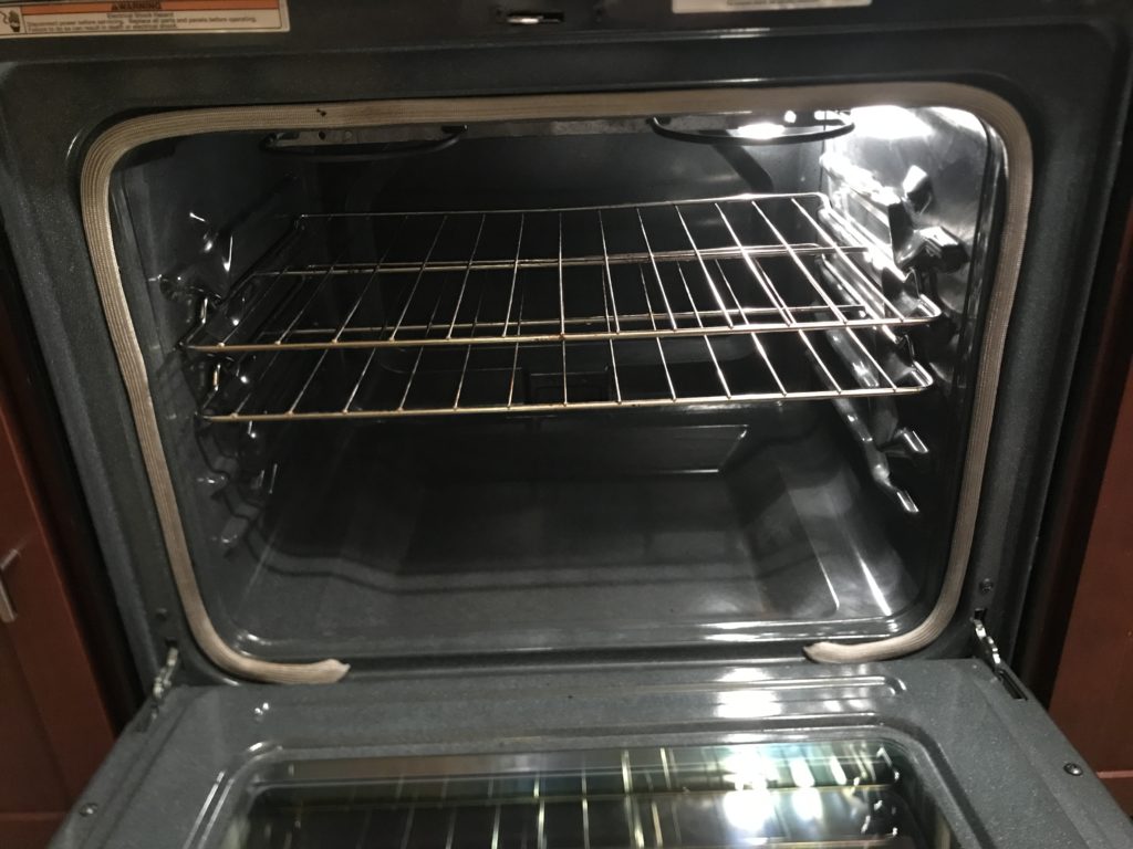 an open oven with a rack inside