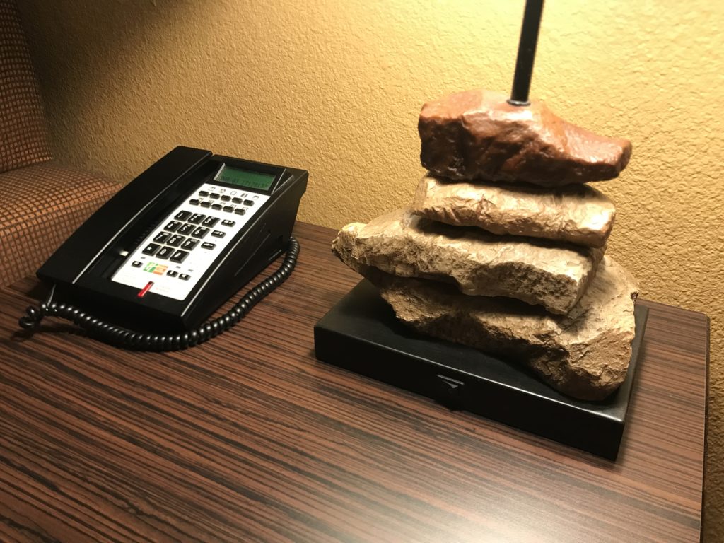 a telephone and rocks on a desk