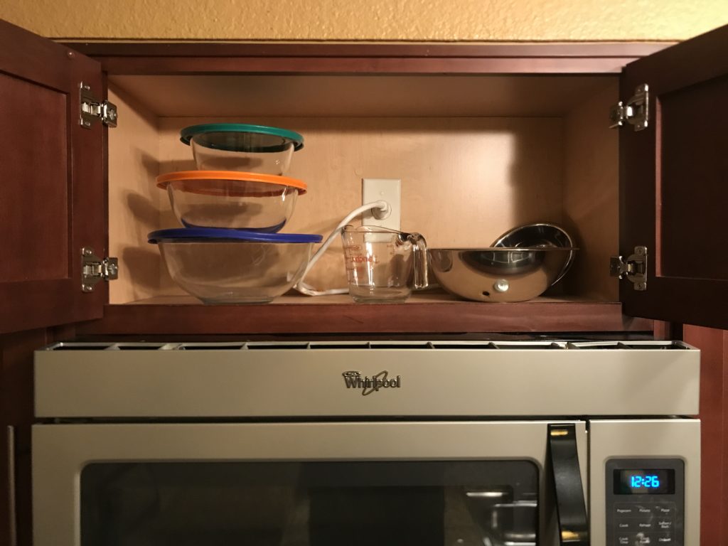 a shelf with a glass bowl and a bowl on top of it