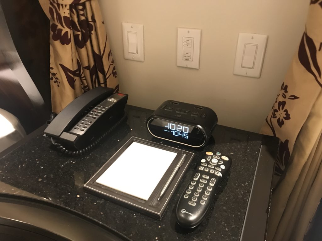 a phone and a clock on a table