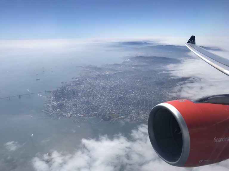 an airplane wing and engine above water