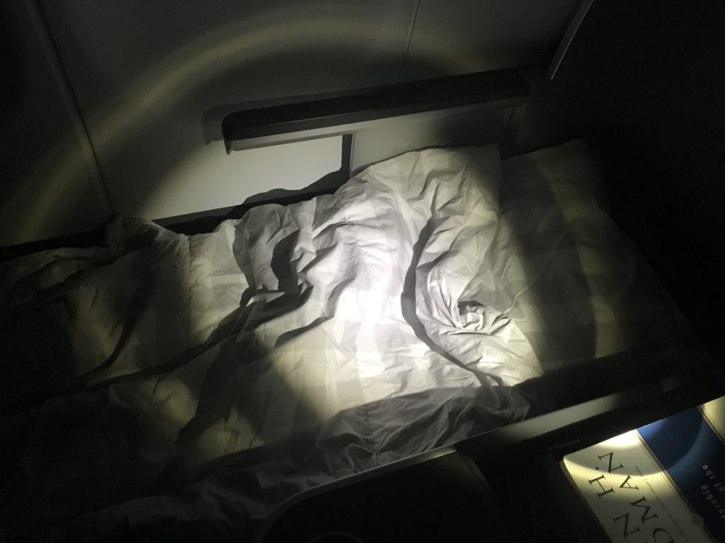 a bed with a light shining on it