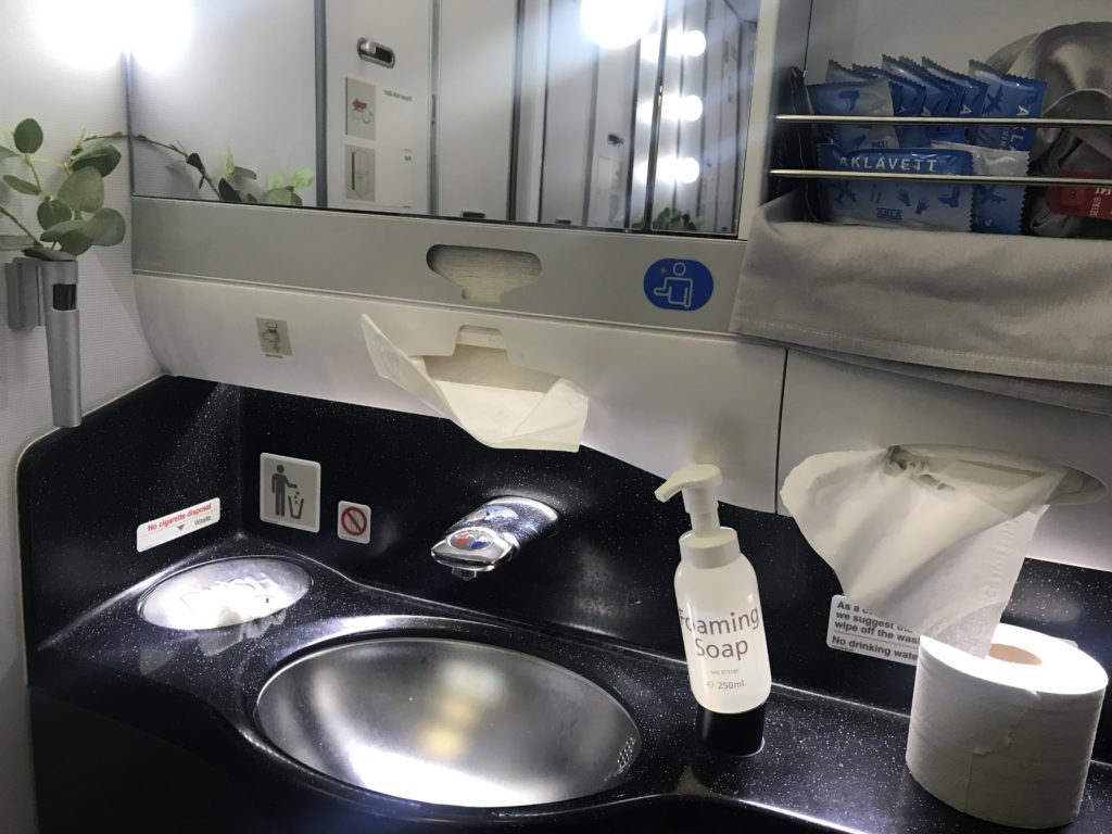 a sink with soap and a mirror