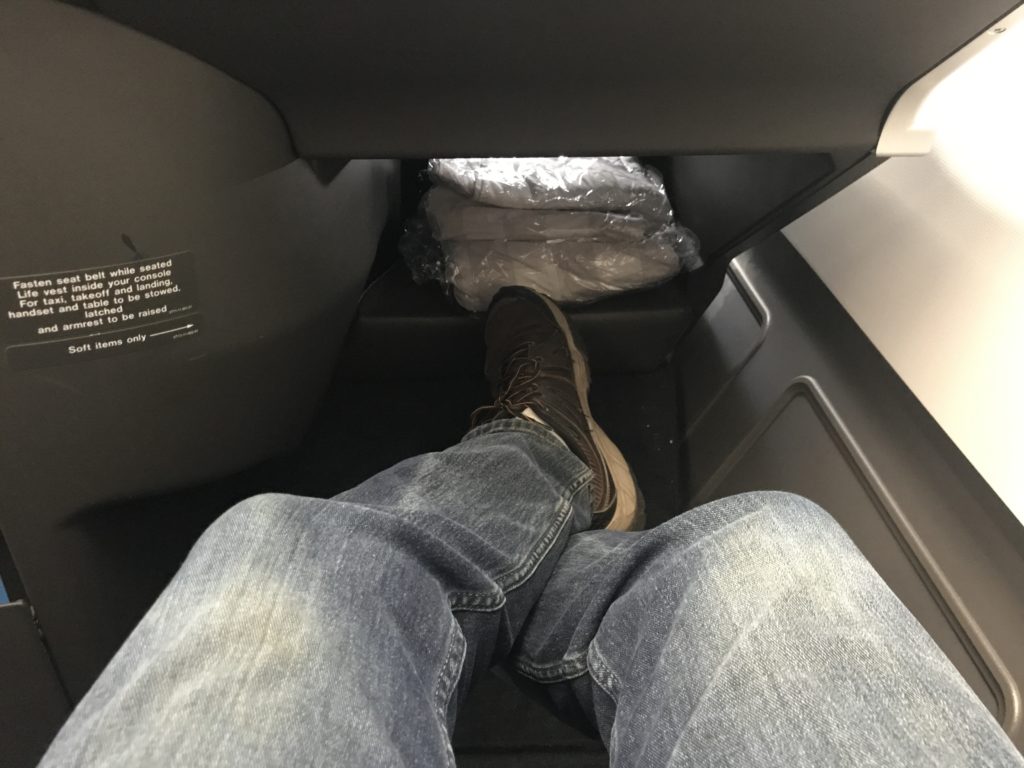 a person's legs in the back of a car
