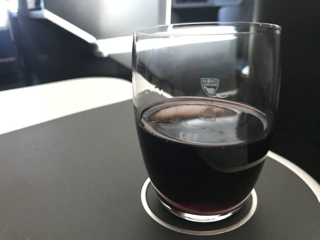 a glass of dark liquid on a table