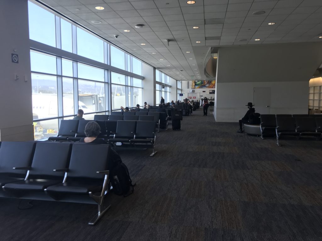 people sitting in chairs in an airport