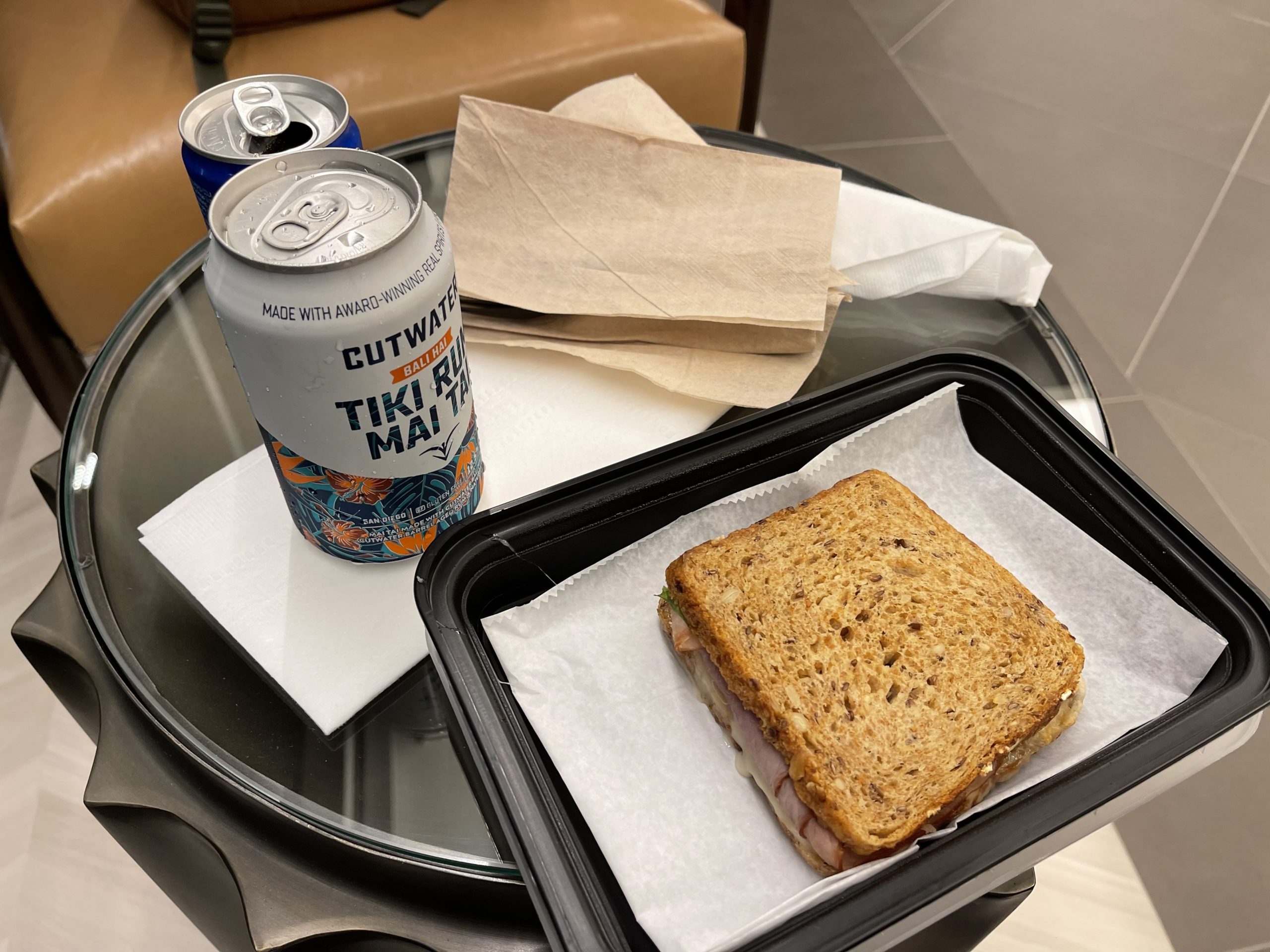a sandwich and soda on a table