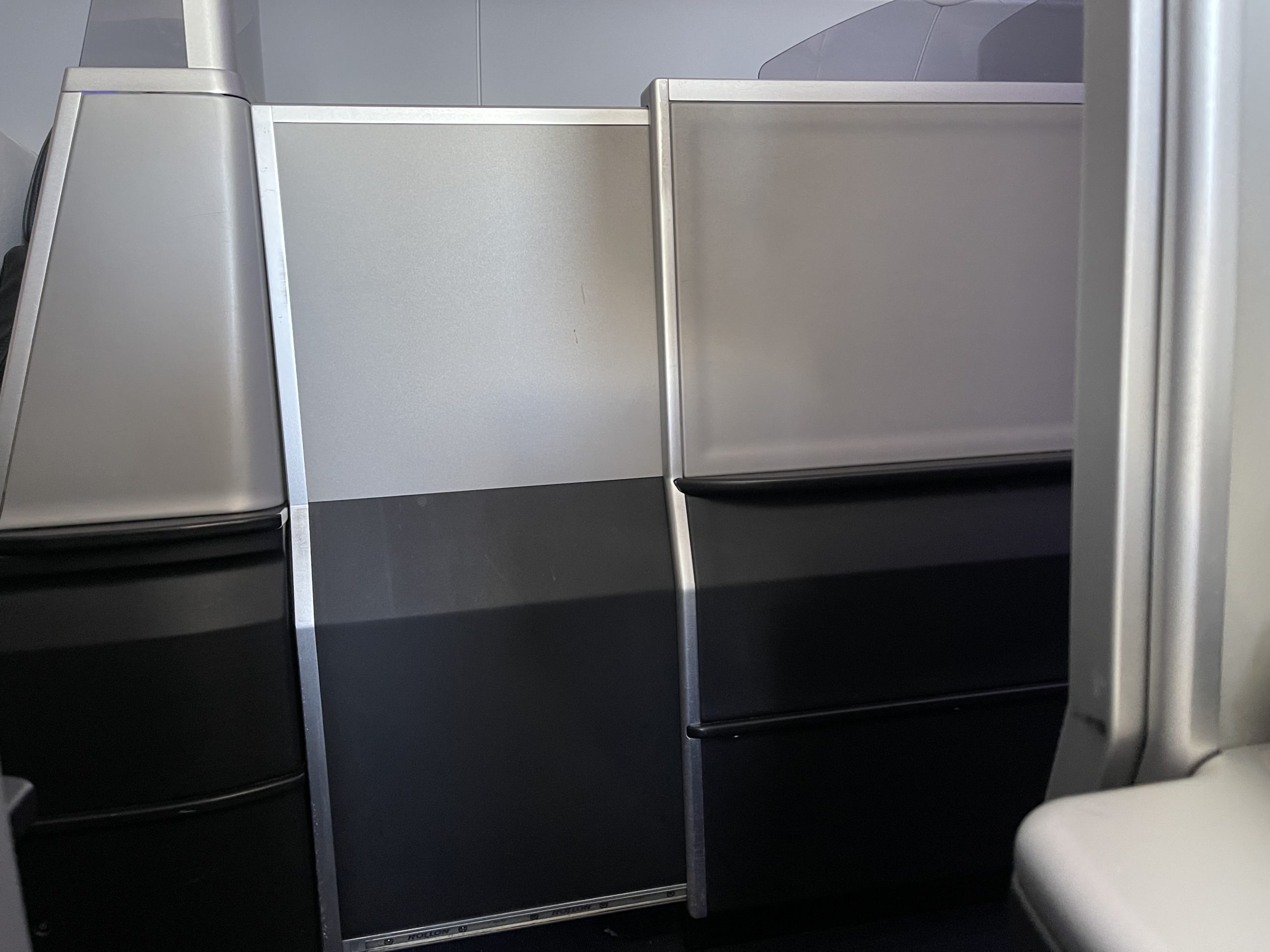 a grey and black partitions in an airplane