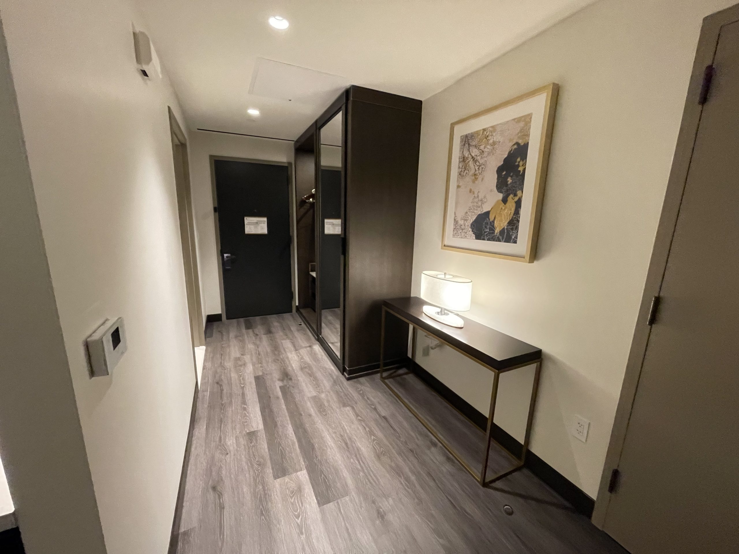 a hallway with a mirror and a table