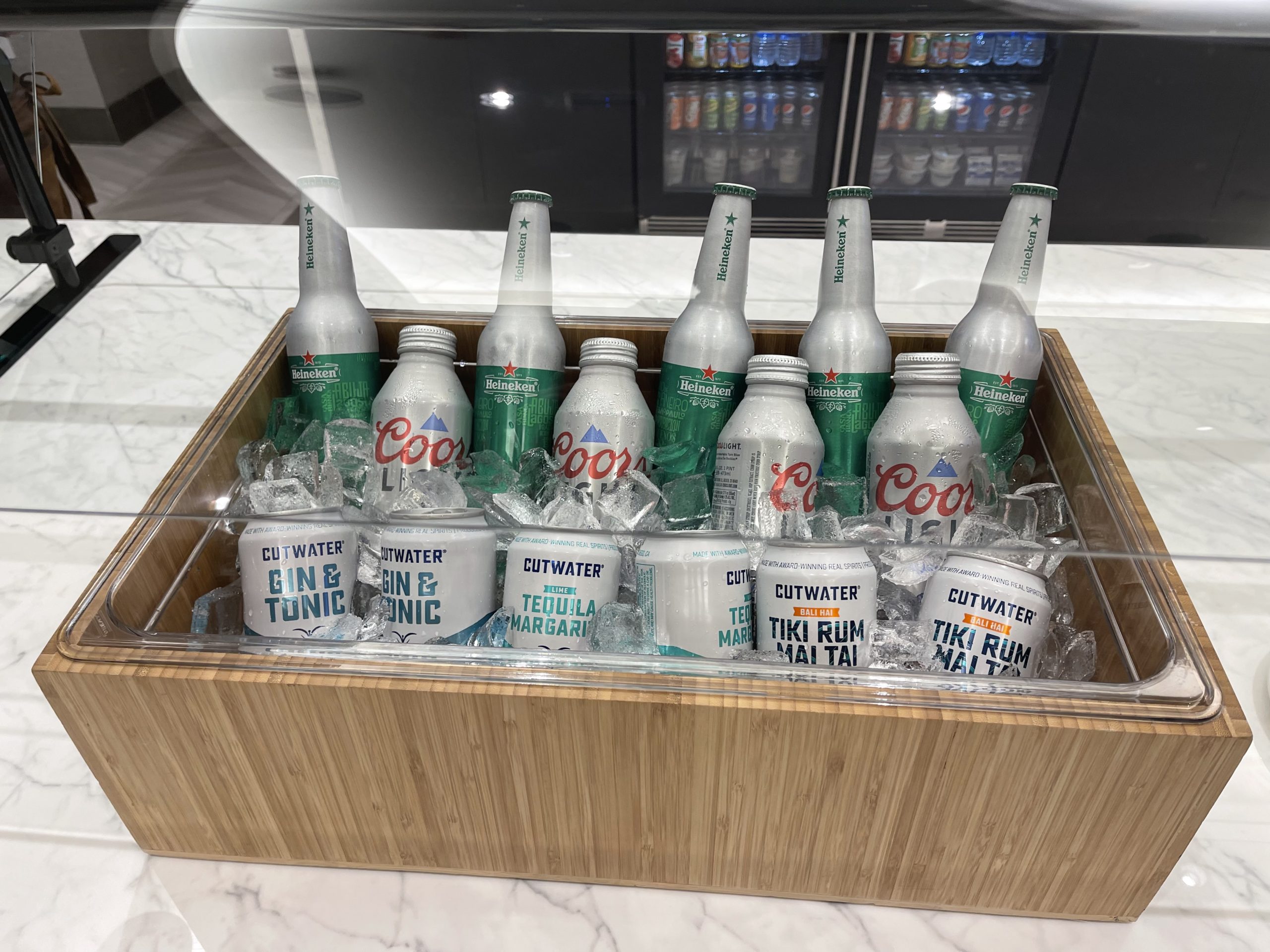 a wooden box with bottles and cans of soda