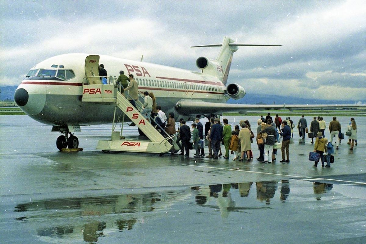 a group of people boarding an airplane