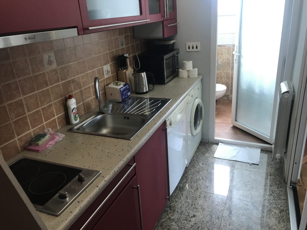 a kitchen with a sink and a washing machine
