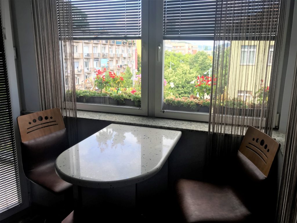 a table and chairs in a room with blinds