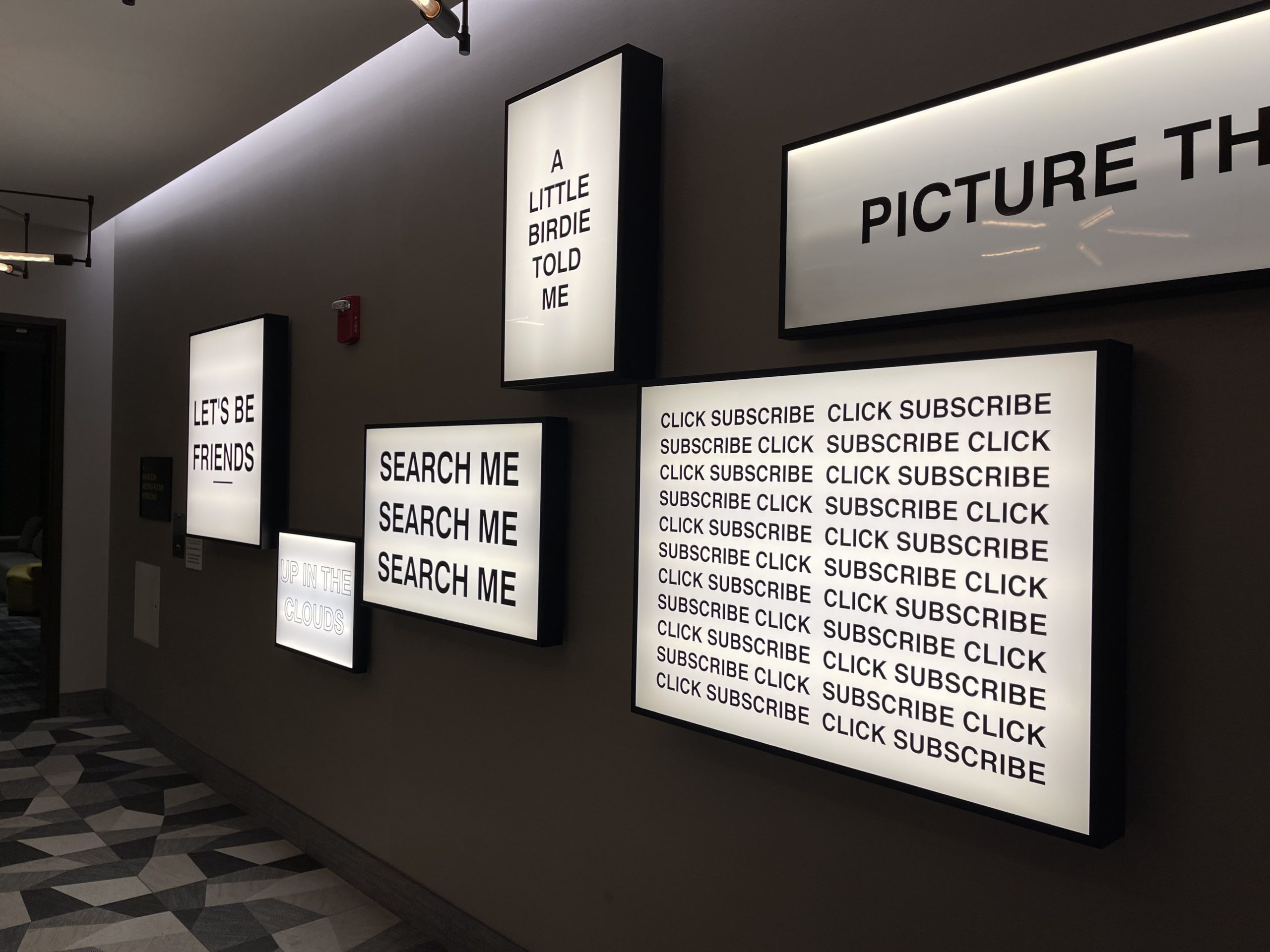 a wall with white rectangular frames with black text on it