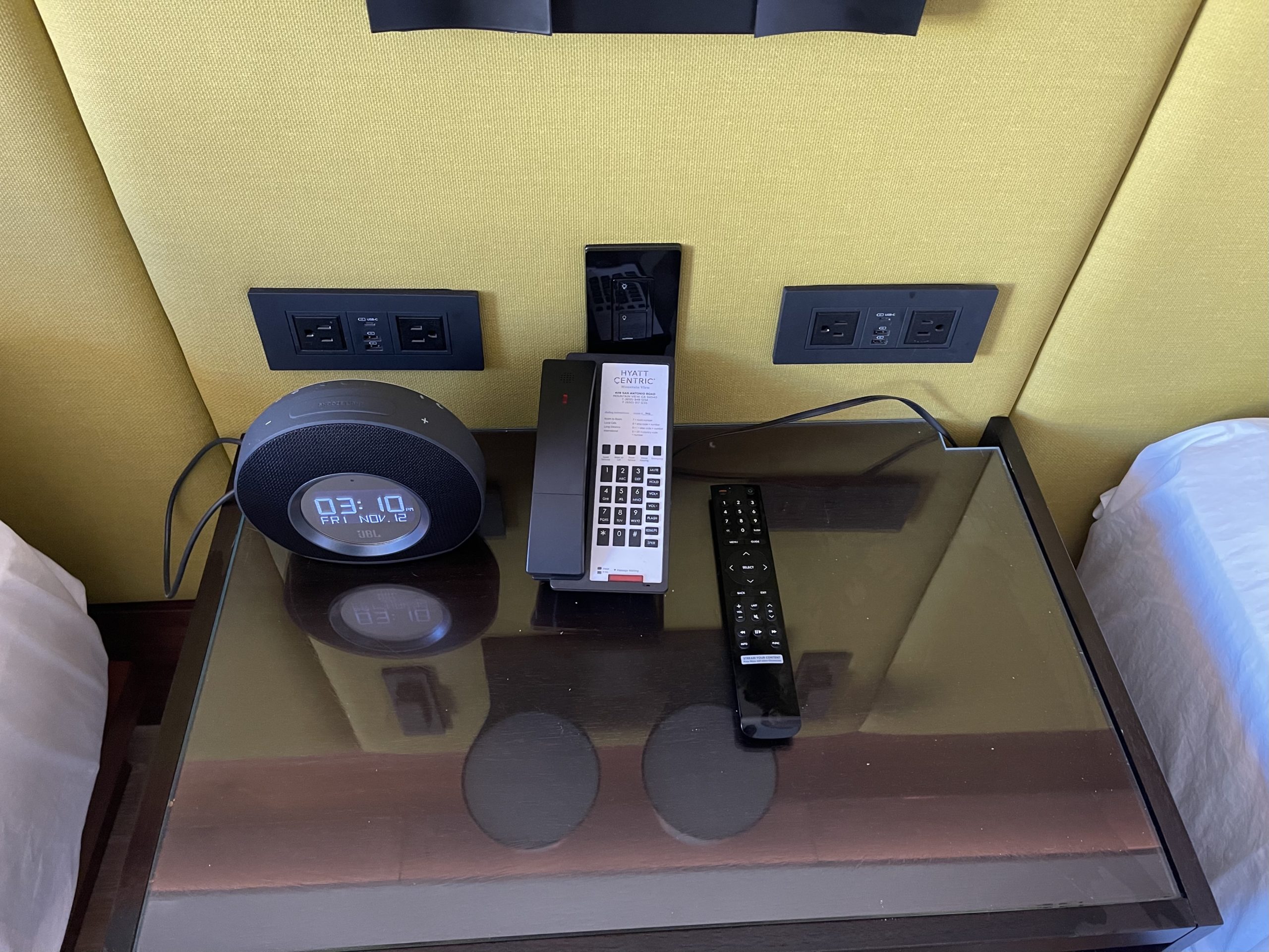 a phone and alarm clock on a table