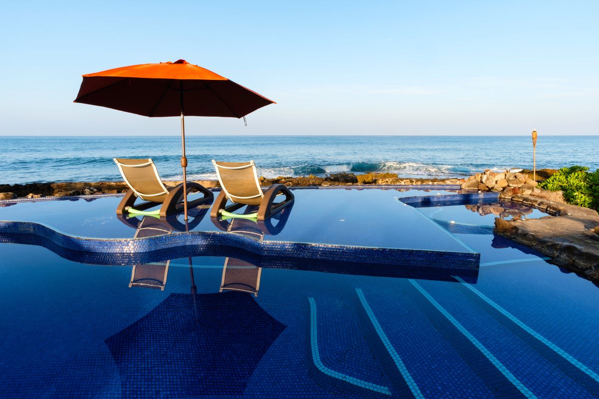 chairs and umbrella by a pool