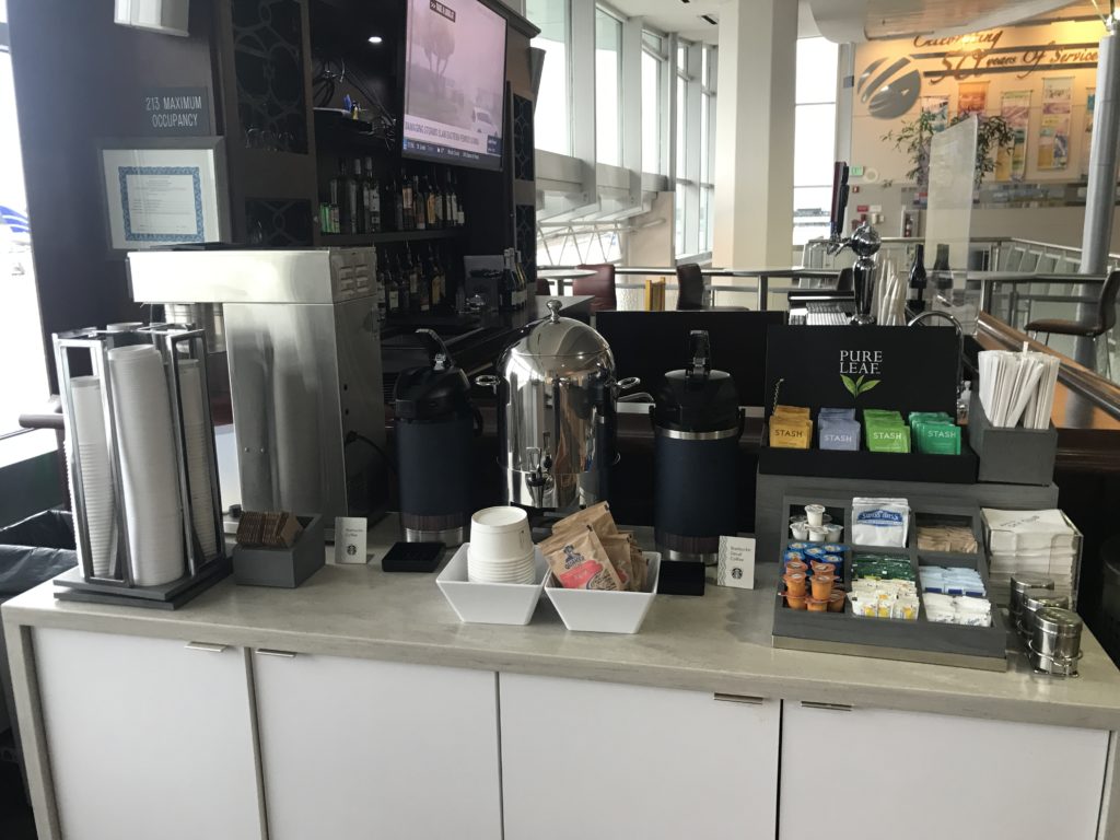 a counter with a coffee machine and other items