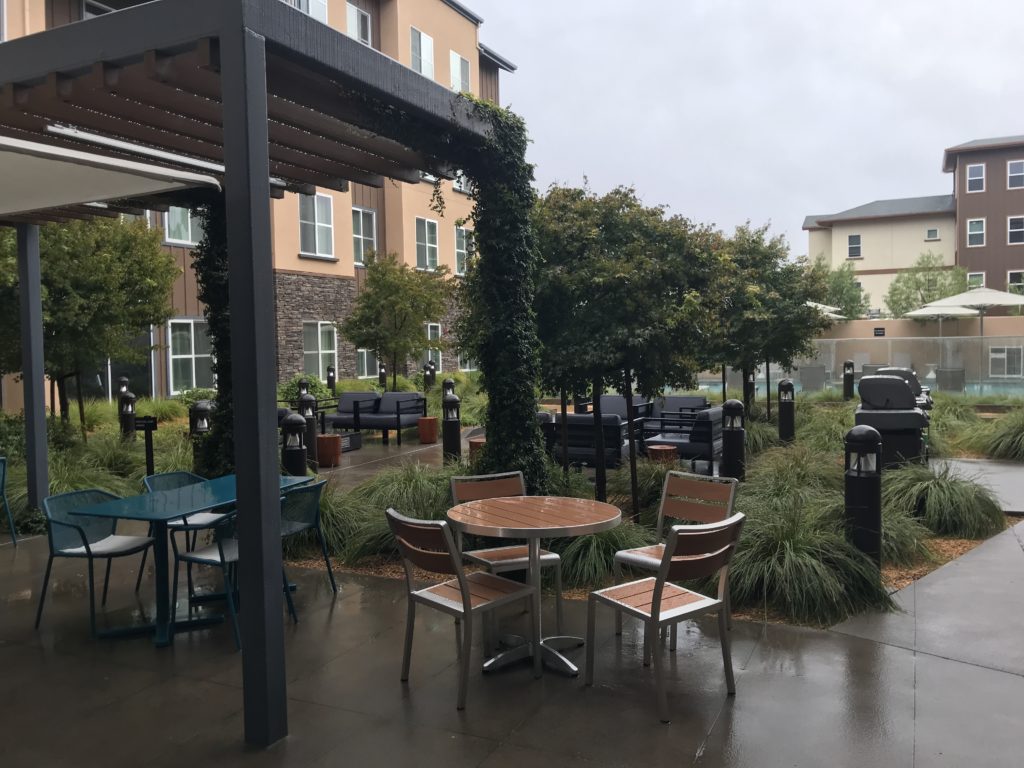 a patio with tables and chairs