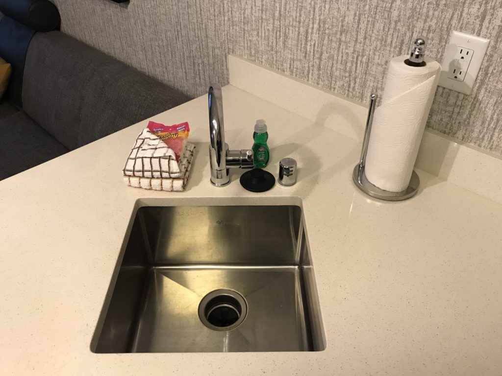 a sink with a faucet and paper towels on it