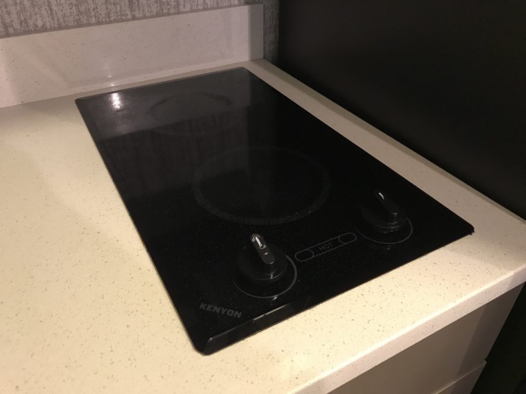 a black stove top with knobs