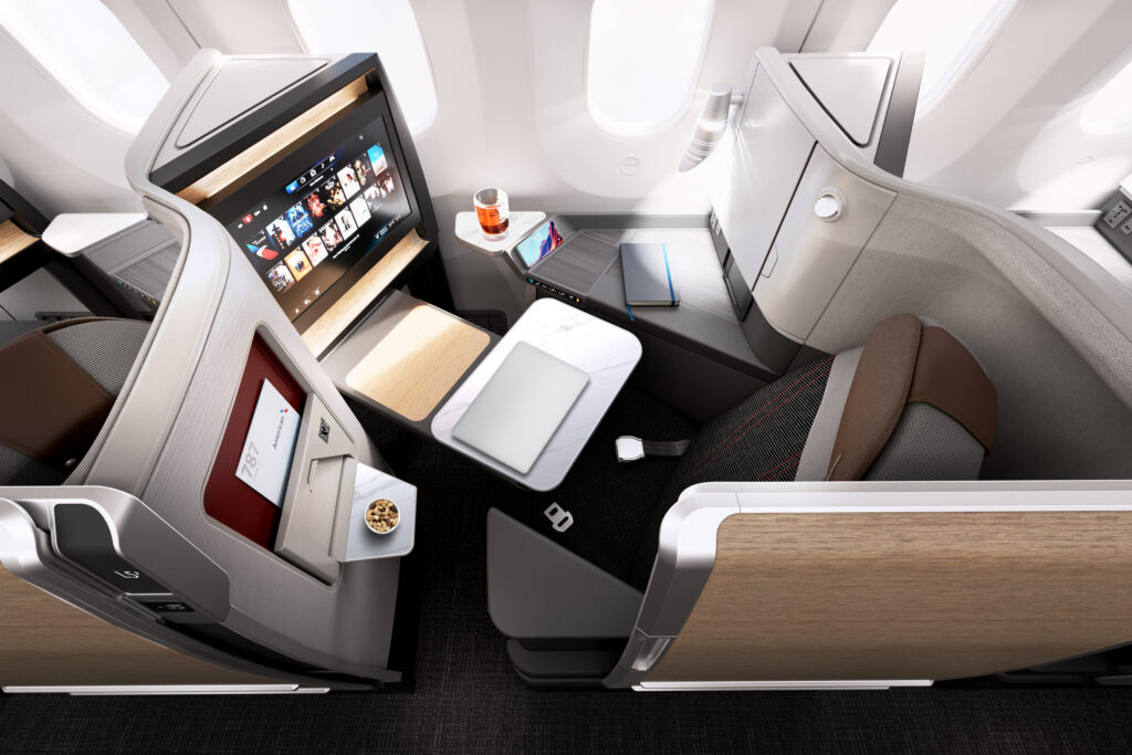 American Airlines future Boeing 787-9 business class seat with tray table, in-flight monitor, and retractable suite door.