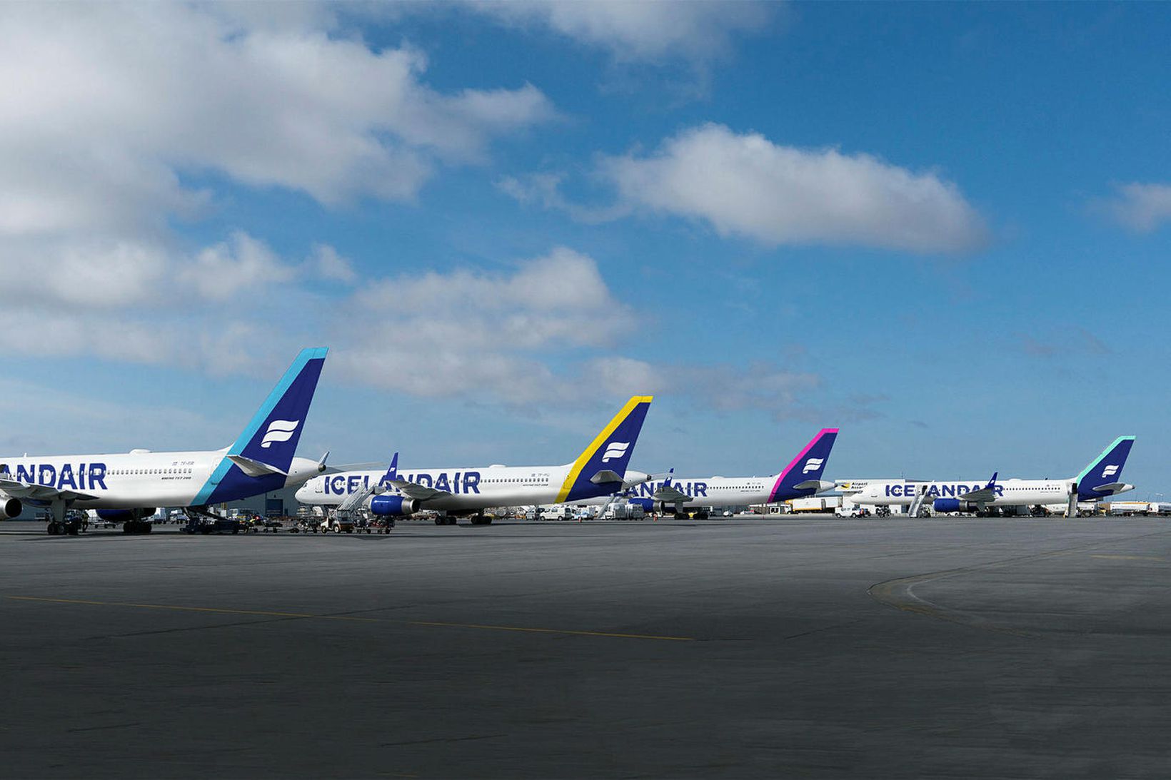 a group of airplanes parked on a runway