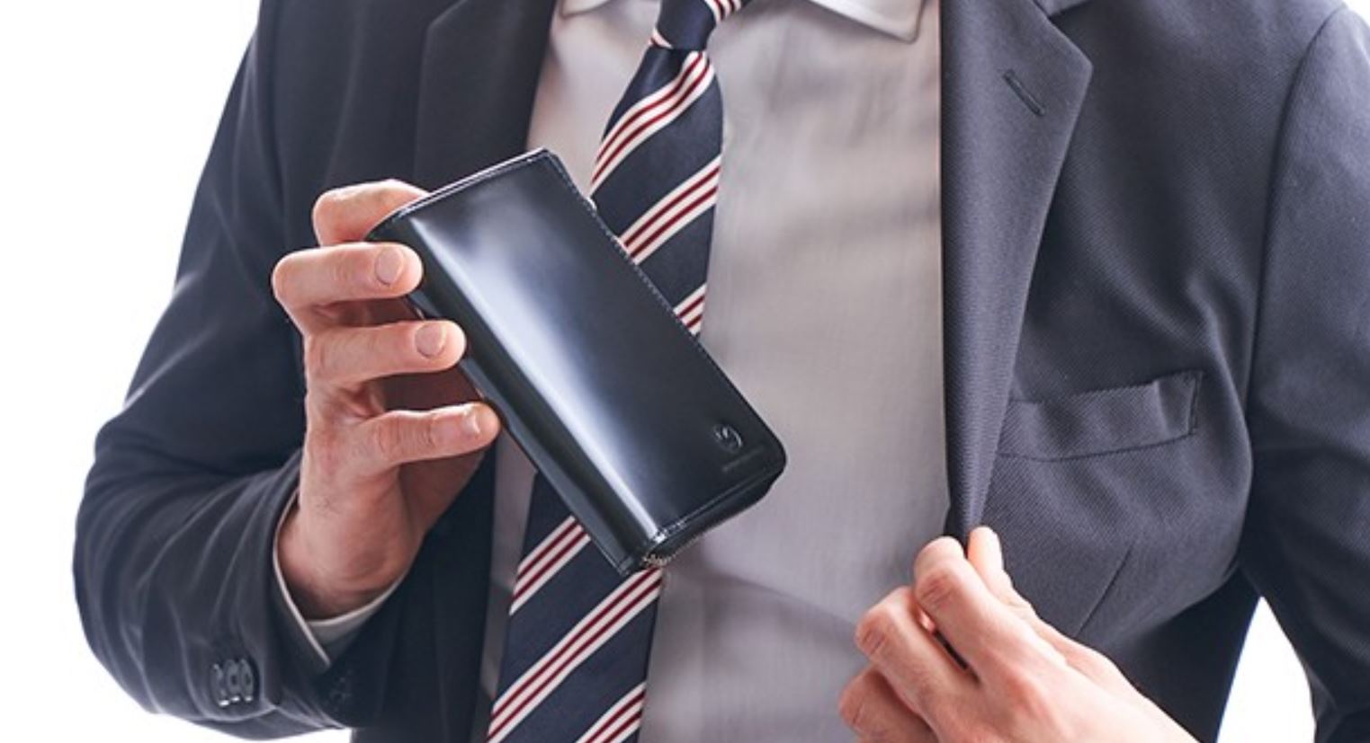 a man in a suit holding a wallet