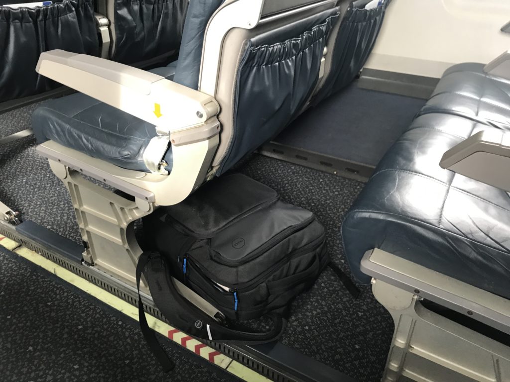 a bag on the floor of an airplane