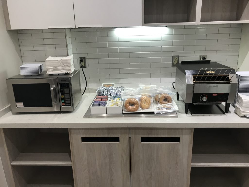 a counter with a microwave and a tray of food
