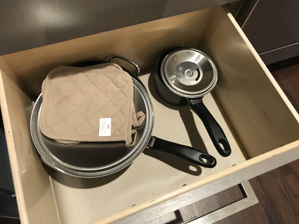 a pan and pot holder in a drawer