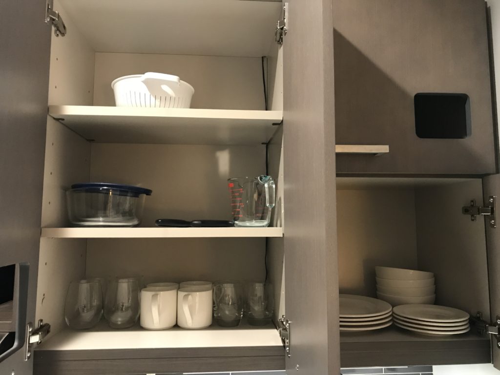 a cupboard with plates and dishes