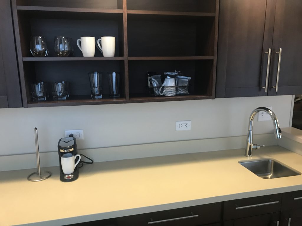 a kitchen with a sink and shelves