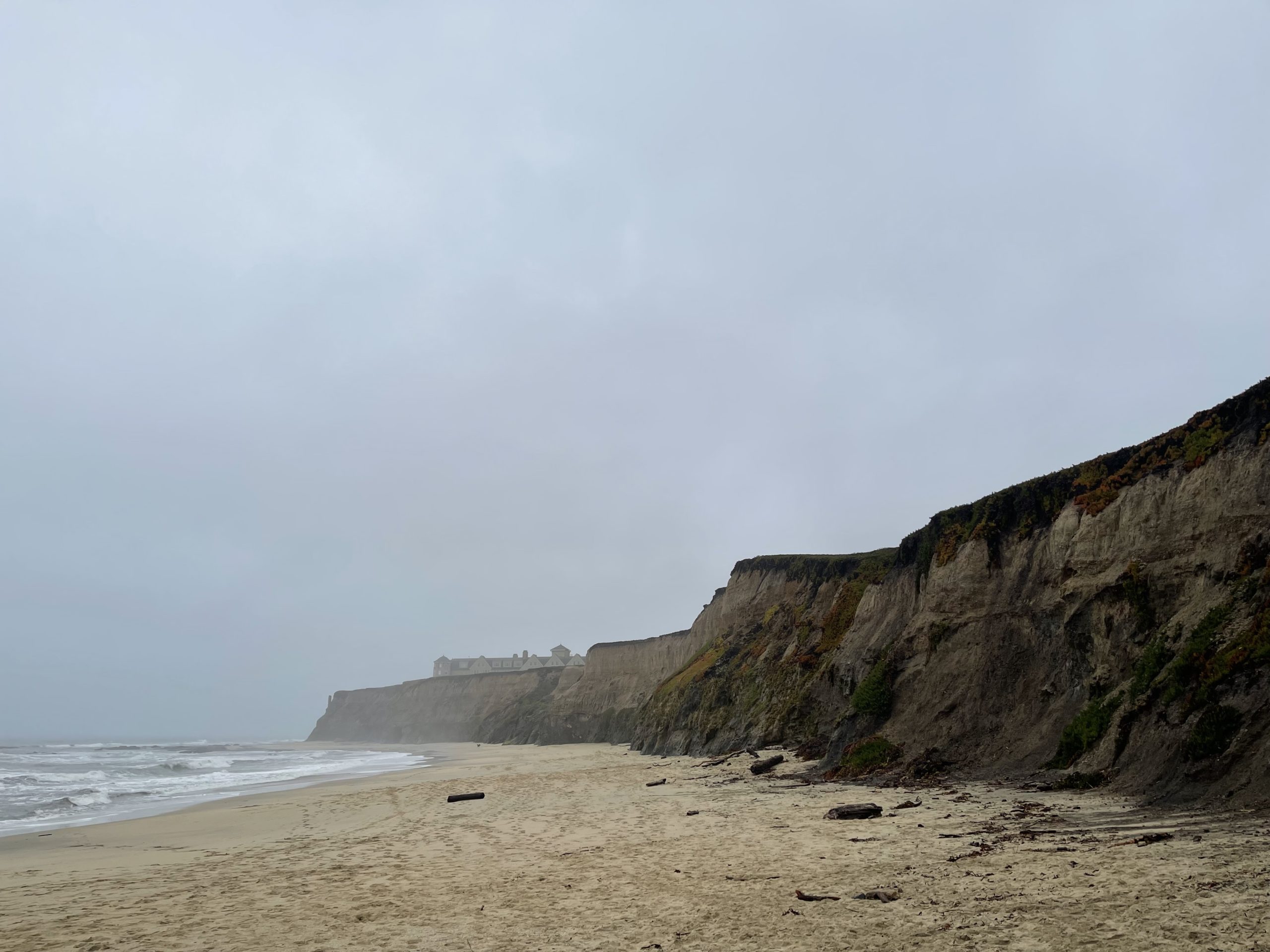 a beach with cliffs and water