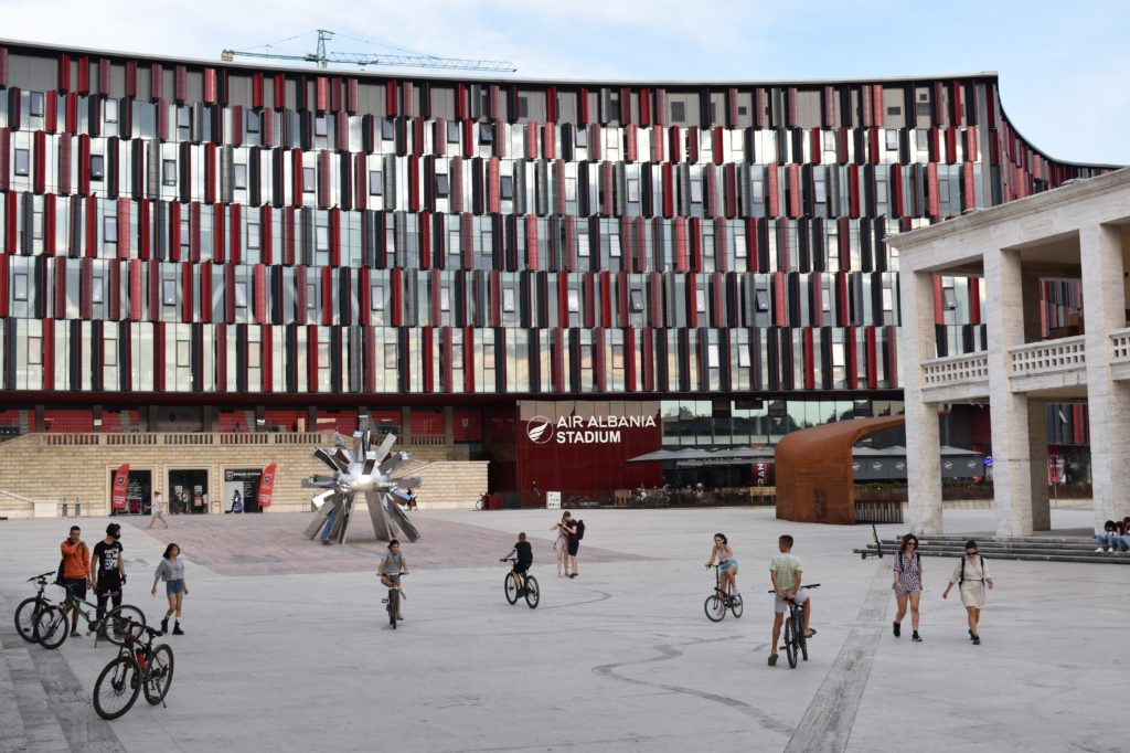 a group of people riding bicycles in a plaza