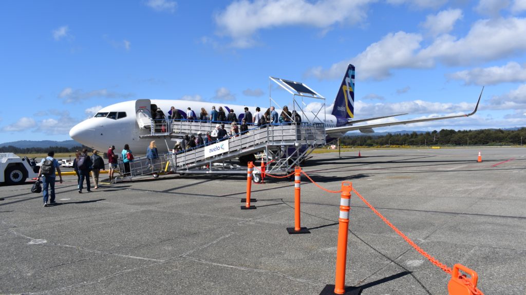 a group of people boarding an airplane