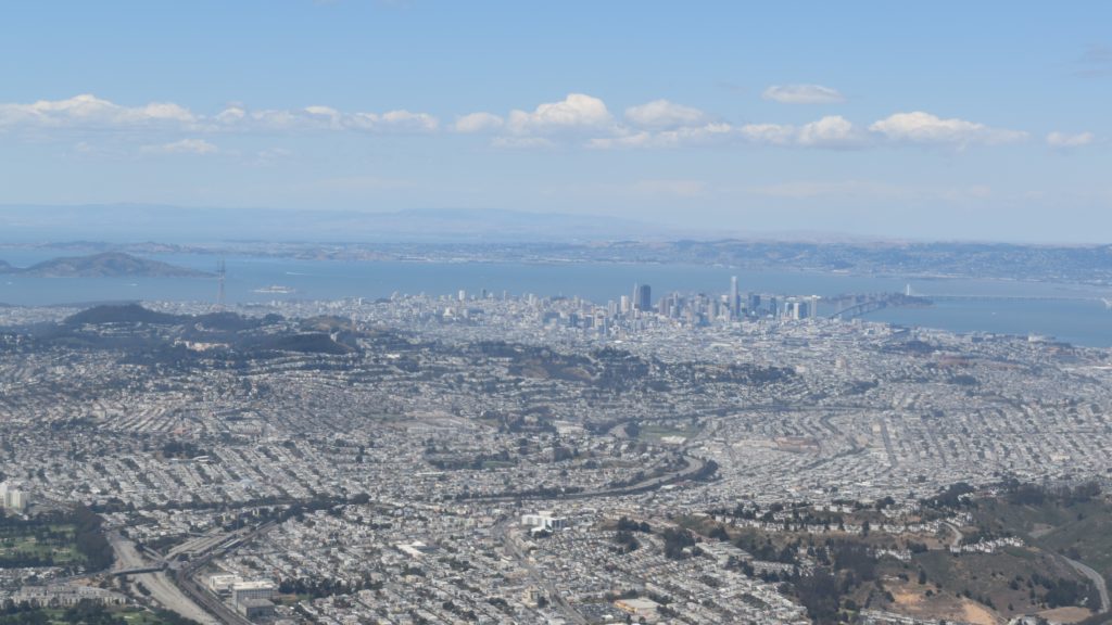 a cityscape with a body of water in the background