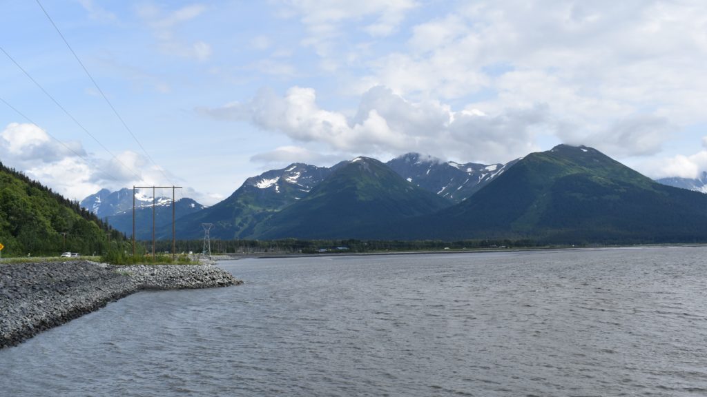 a body of water with mountains in the background