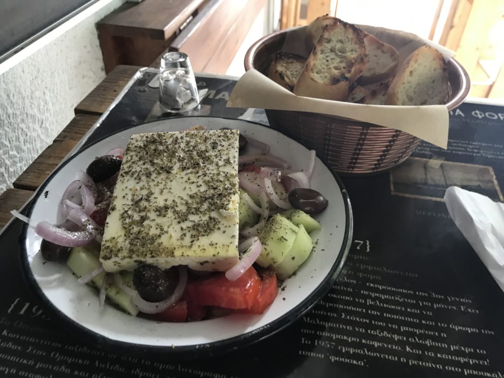 a bowl of food and a basket of bread