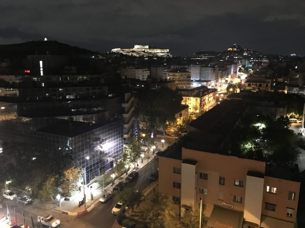 a city at night with buildings and trees