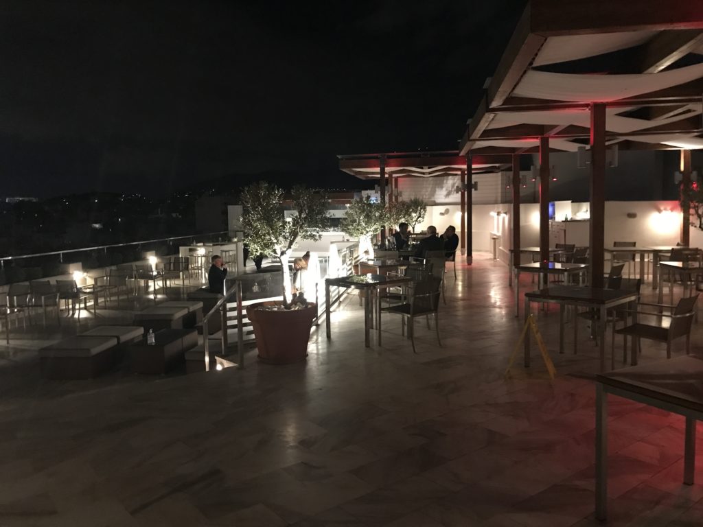 a group of people sitting at tables on a patio