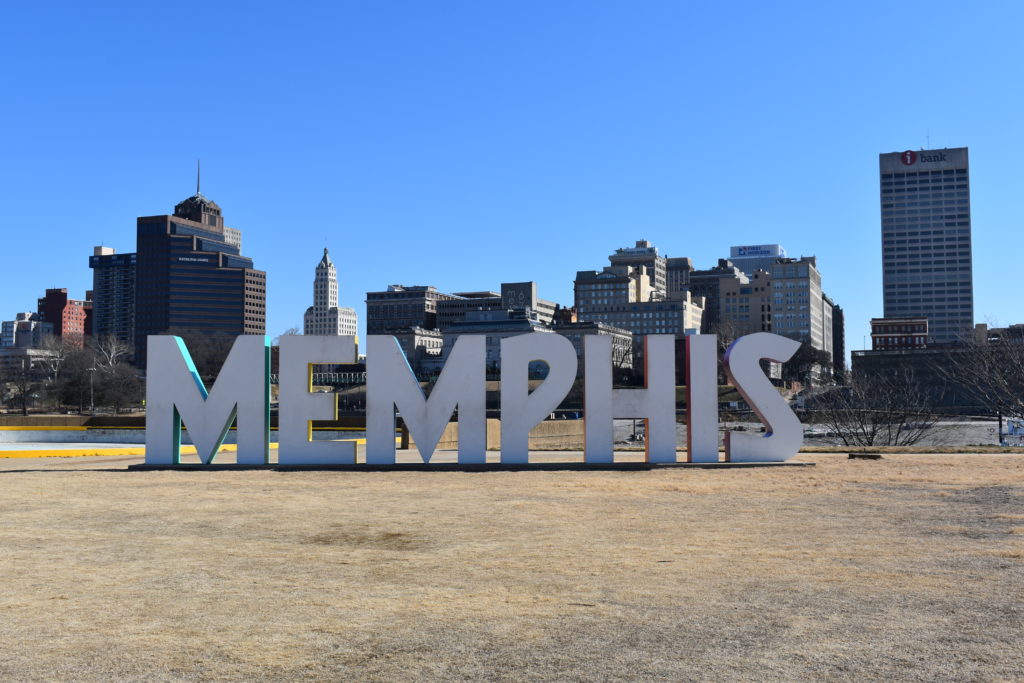 a large sign in front of a city