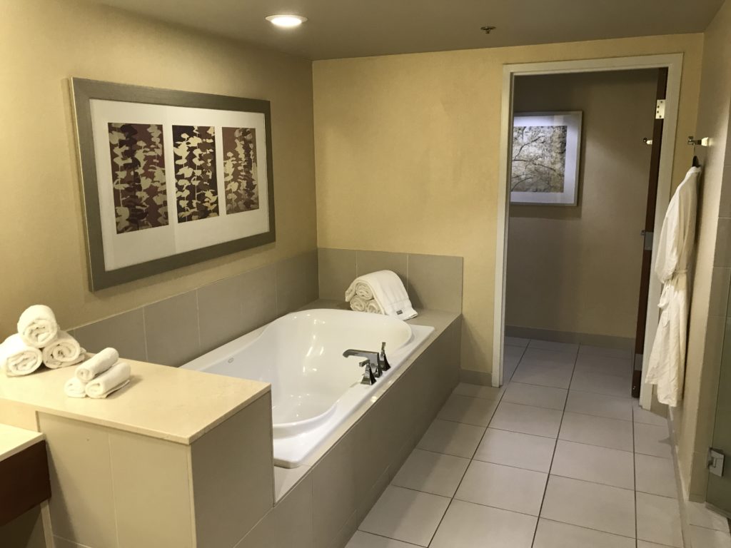 a bathroom with a bathtub and a tile floor