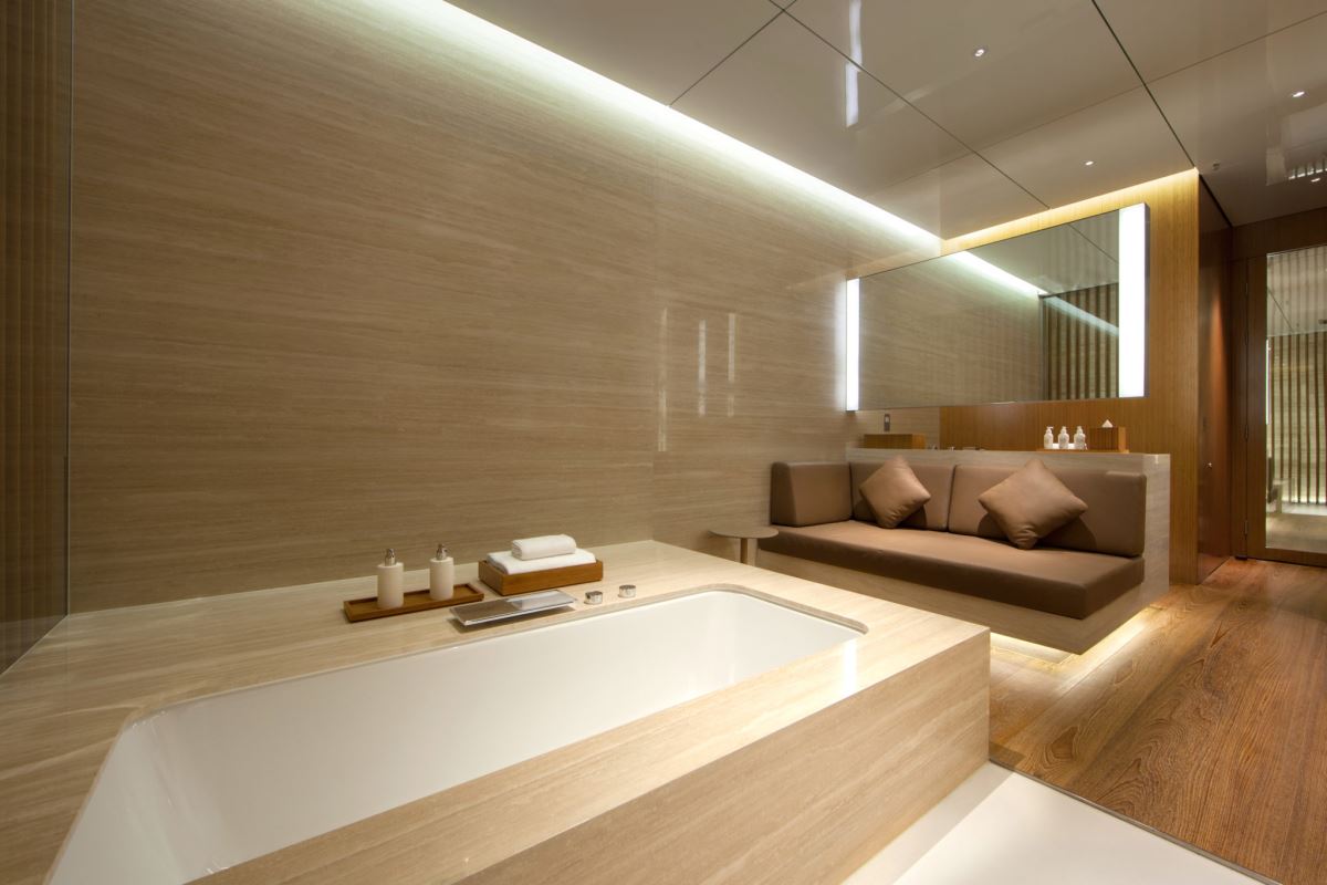 a bathroom with a bathtub and a couch