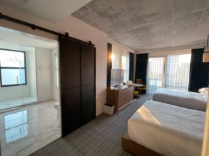 a room with two beds and a sliding door