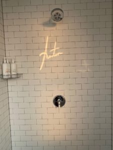 a shower with a faucet and a shower head