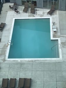 a pool with chairs and a table