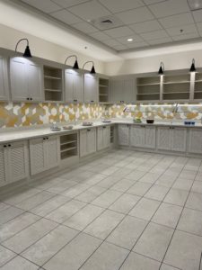 a kitchen with white cabinets and a tile floor