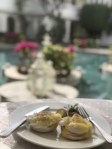 food on a plate with a pool in the background