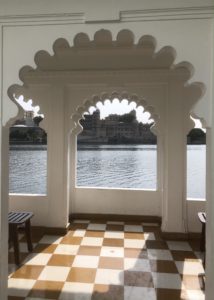 a white archway with a checkered floor