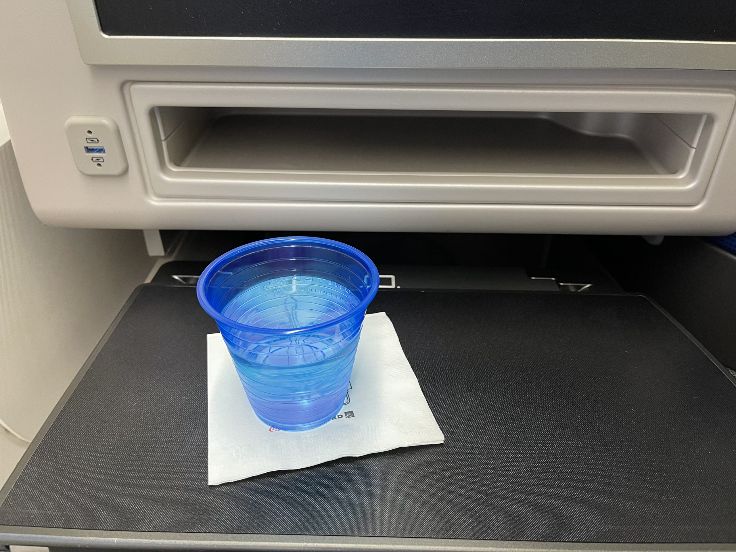 a plastic cup on a napkin in a vehicle